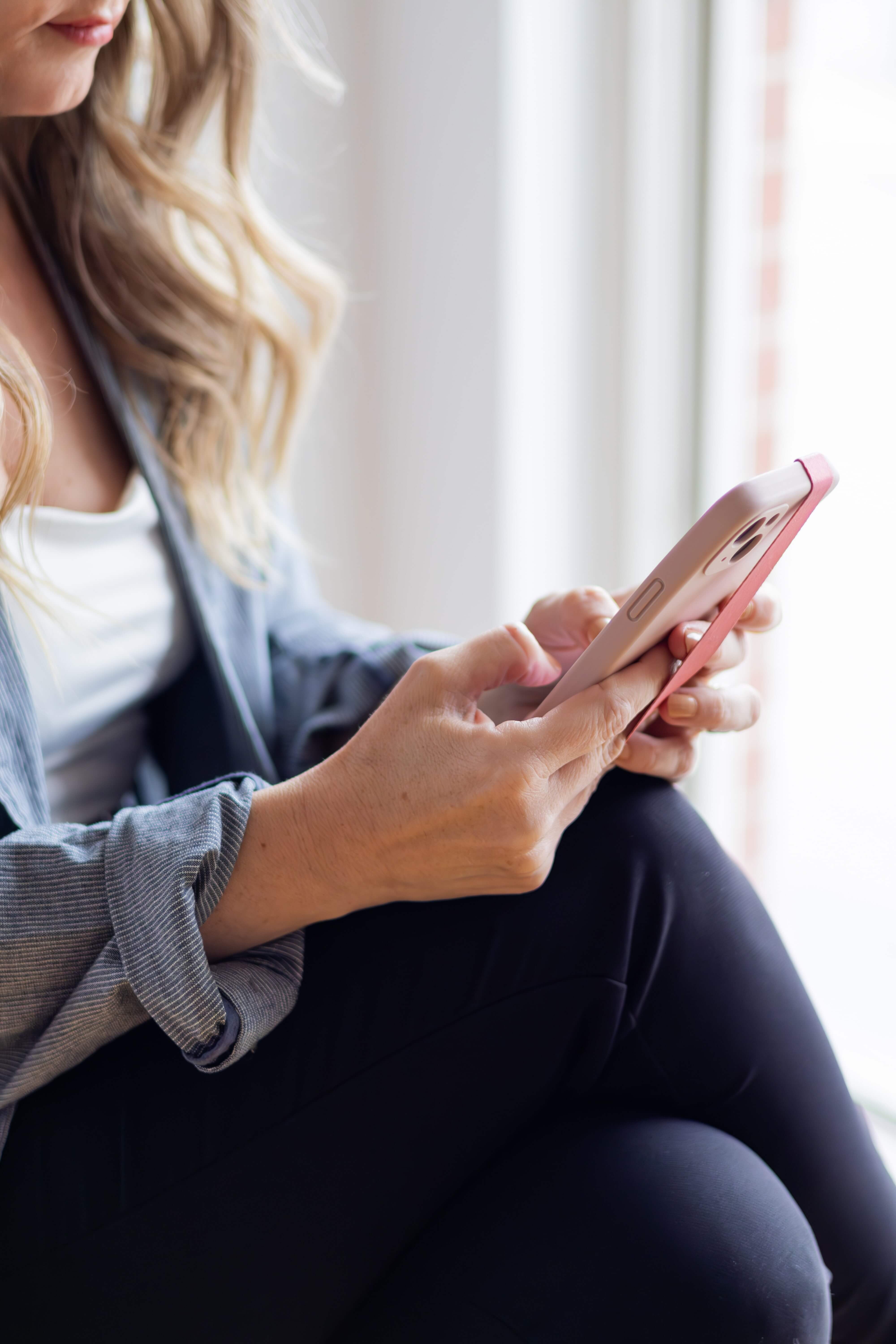 Brand photo of a woman holding a cell phone